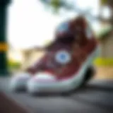 Stylish brown Converse shoes on a wooden surface